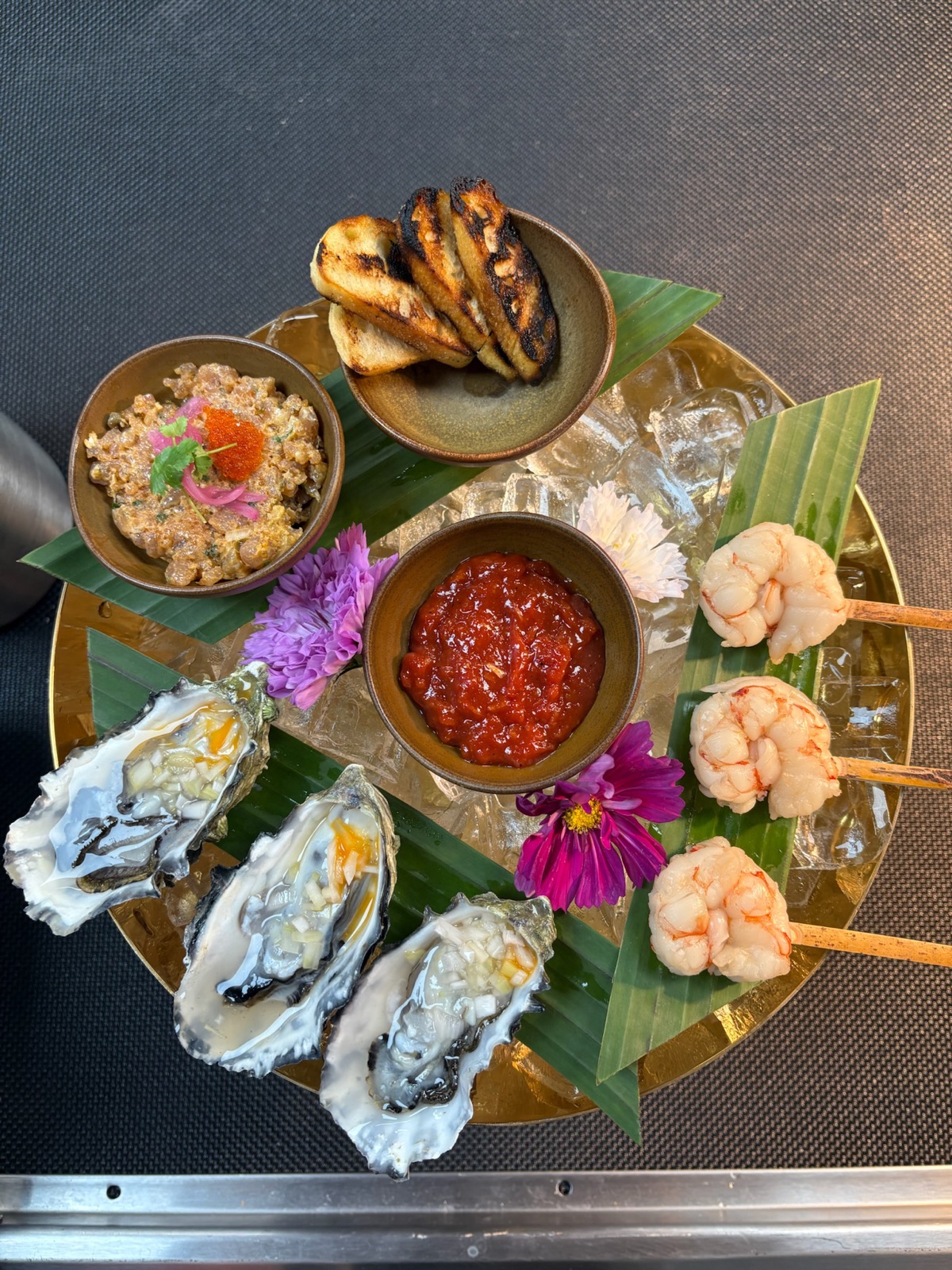 An iced seafood display with oysters and prawns